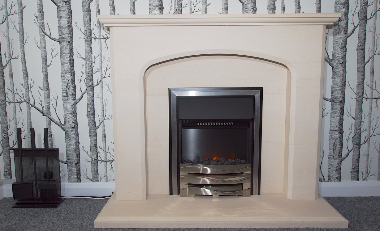 An electric fire in a traditional limestone fireplace