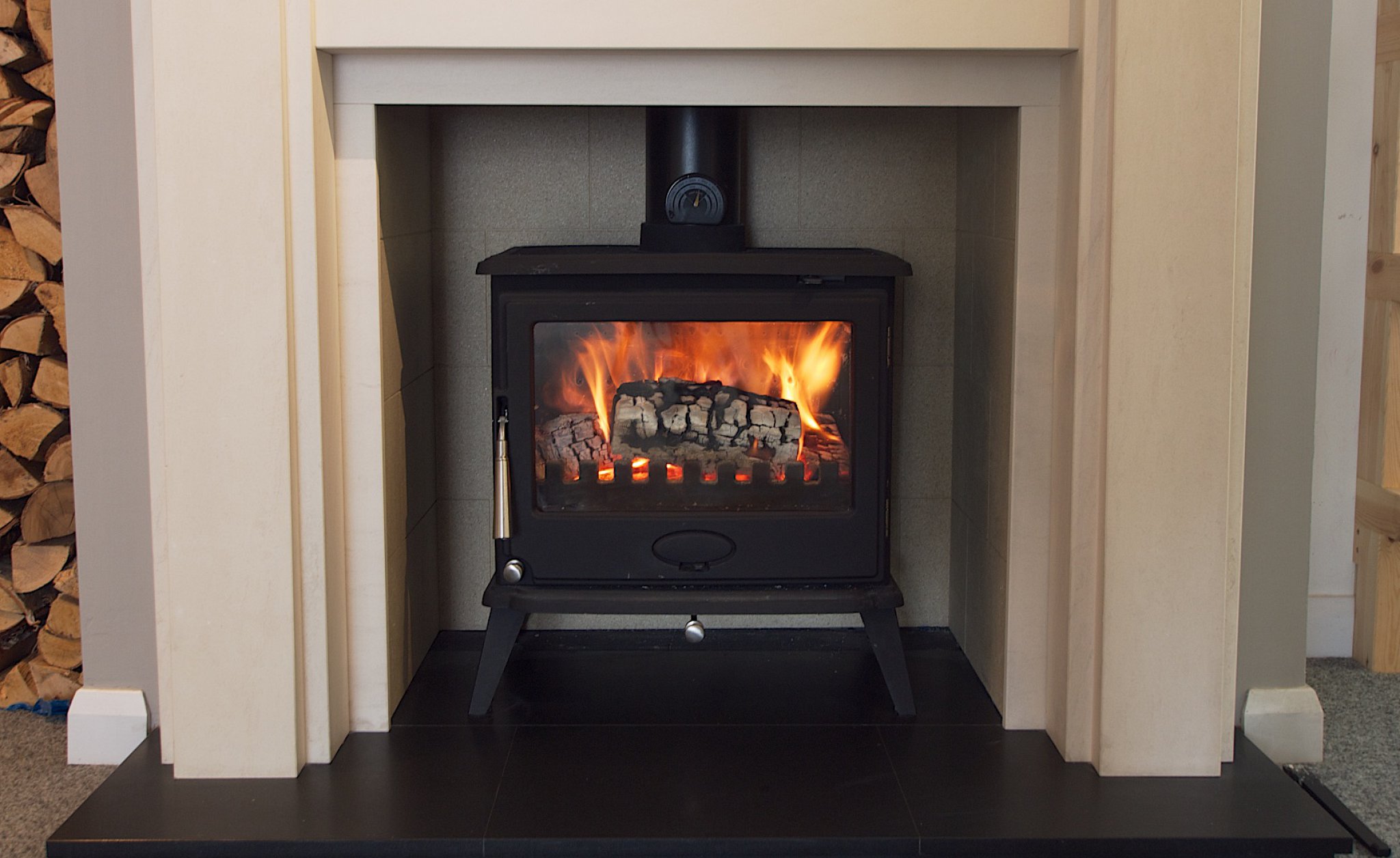 A Newman wood burning stove burning efficiently with kiln dried logs